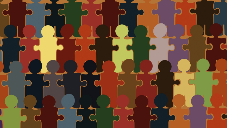 Figuren in Form von Puzzlestücken in unterschiedlichen Farben, dicht aneinandergereiht. Das Bild symbolisiert Vielfalt und gesellschaftliche Zusammengehörigkeit.