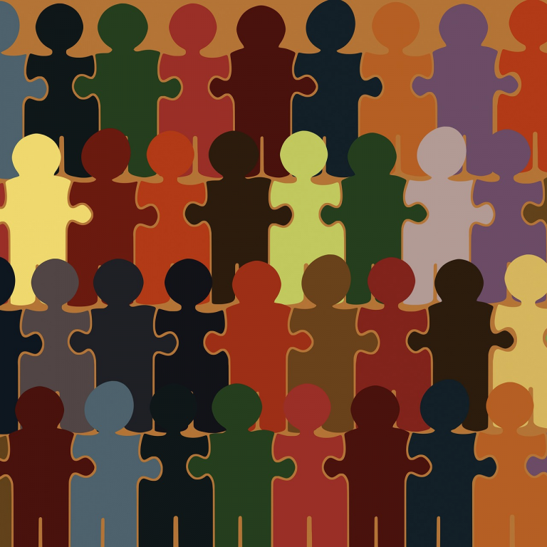 Figuren in Form von Puzzlestücken in unterschiedlichen Farben, dicht aneinandergereiht. Das Bild symbolisiert Vielfalt und gesellschaftliche Zusammengehörigkeit.