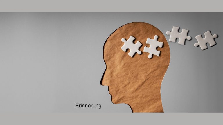 Illustration eines Kopfes aus Papier mit Puzzle-teilen, die Gedanken oder Erinnerung symbolisieren